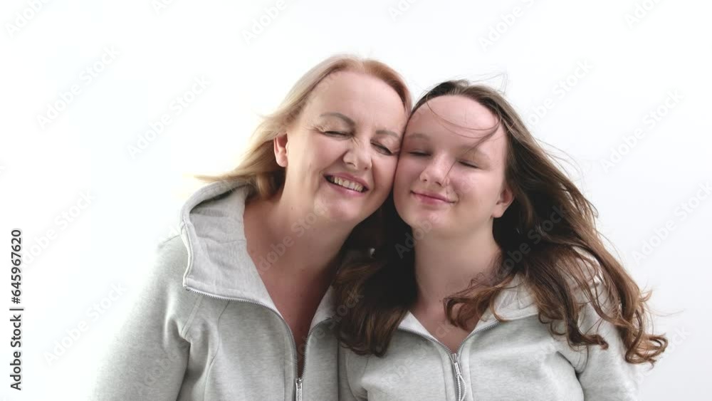 Pretty smiling child daughter embrace mom look at camera. Happy beautiful family young adult single mother foster parent and cute kid girl hug cuddle enjoy sweet tender love concept. Pretty smiling child daughter embrace mom look at camera. Happy beautiful family young adult single mother foster parent and cute kid girl hug cuddle enjoy sweet tender love concept.