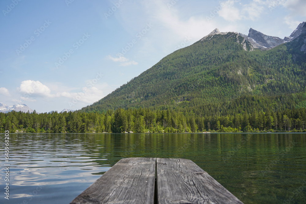 wooden pier on lake in the mountains in summer