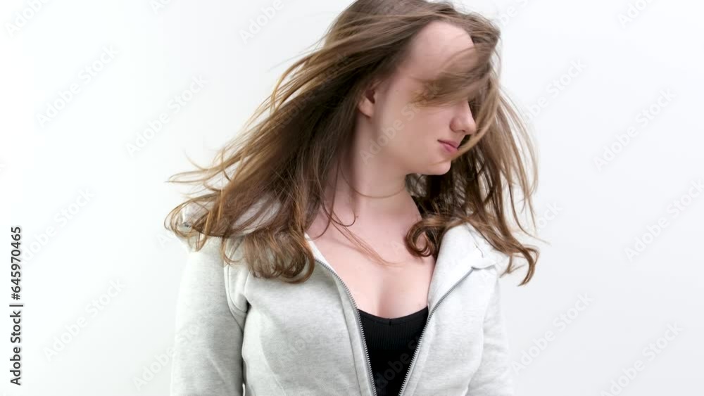 hair develops in the studio young girl teenager waves her head from right to left slow motion video gray sports jacket black top. adolescence innocent virgin beauty hair develops in the studio young girl teenager waves her head from right to left slow motion video gray sports jacket black top. adolescence innocent virgin beauty