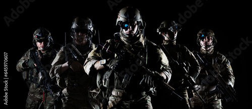 United States Army rangers with assault rifle on dark background