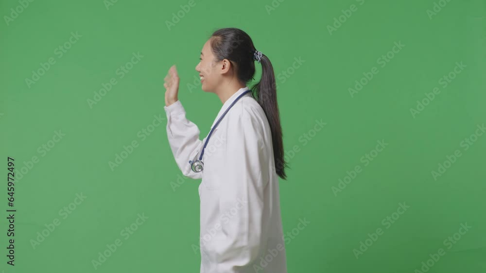 Side View Of Asian Female Doctor With Stethoscope Waving Hand And Smiling While Walking On Green Screen Background In The Hospital
Side View Of Asian Female Doctor With Stethoscope Waving Hand And Smiling While Walking On Green Screen Background In The Hospital