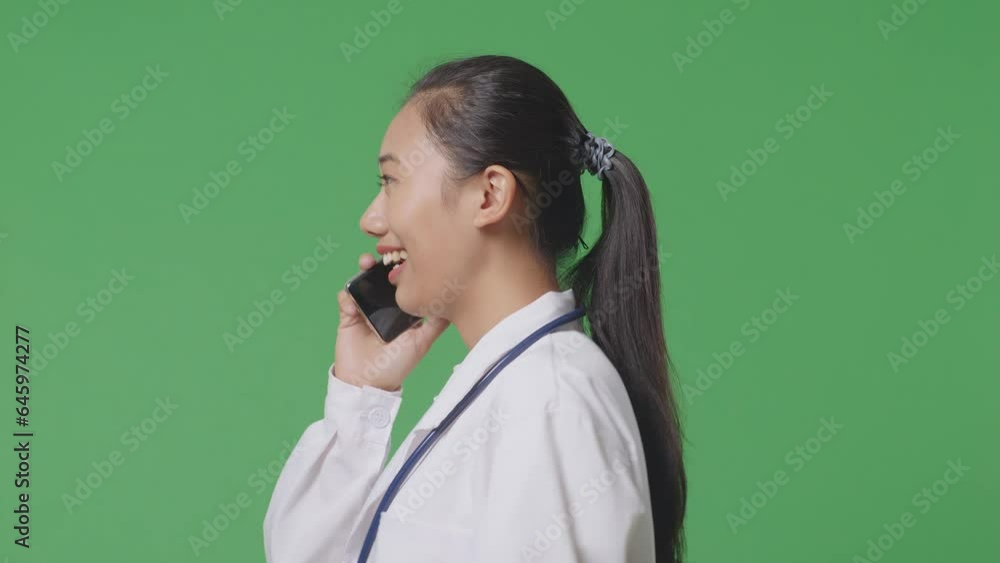 Close Up Of Side View Asian Female Doctor With Stethoscope Talking On Smartphone While Walking On Green Screen Background In The Hospital
Close Up Of Side View Asian Female Doctor With Stethoscope Talking On Smartphone While Walking On Green Screen Background In The Hospital