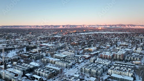 Denver suburbs aerial drone video looking towards Rocky Mountains on snowy winter morning  photo