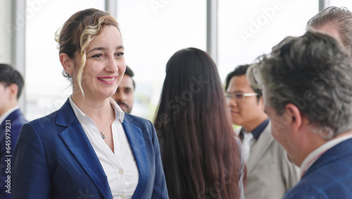 Smiling face of Caucasian businesswoman in suit talking with partner at seminar of company. Confident businesswoman manager. Business concept