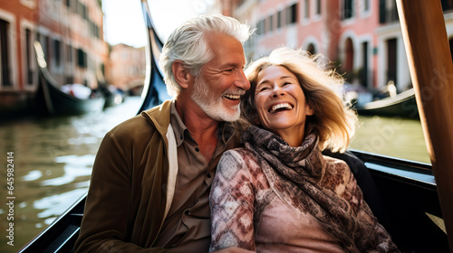 Happy mature couple on a gondola trip during a vacation. Concept of travel, tourism and sightseeing at a senior age, enjoying retirement. Shallow field of view.