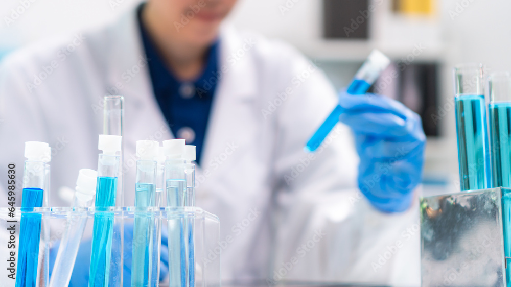 Fototapeta premium Scientist wearing glassware research in chemistry laboratory for pharmaceutical using beaker and test tube equipment for analysis microbiology