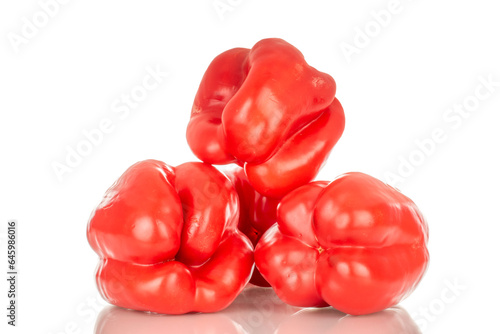 Four red sweet peppers, macro, isolated on white background. © Oleksandr