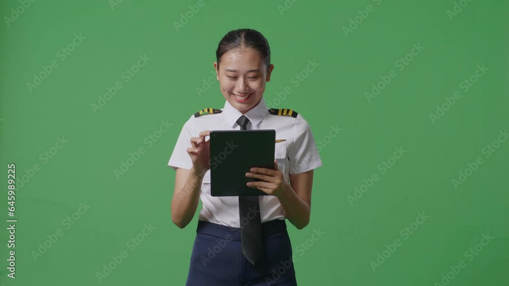 Asian Woman Pilot Using A Tablet While Standing In The Green Screen Background Studio
Asian Woman Pilot Using A Tablet While Standing In The Green Screen Background Studio