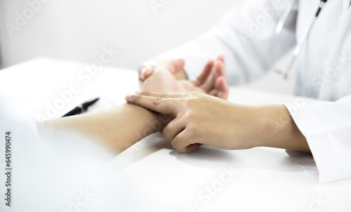 Wallpaper Mural The female doctor measured blood pressure, the patient examined the heartbeat and sat down to talk about health care closely. health care concept Torontodigital.ca