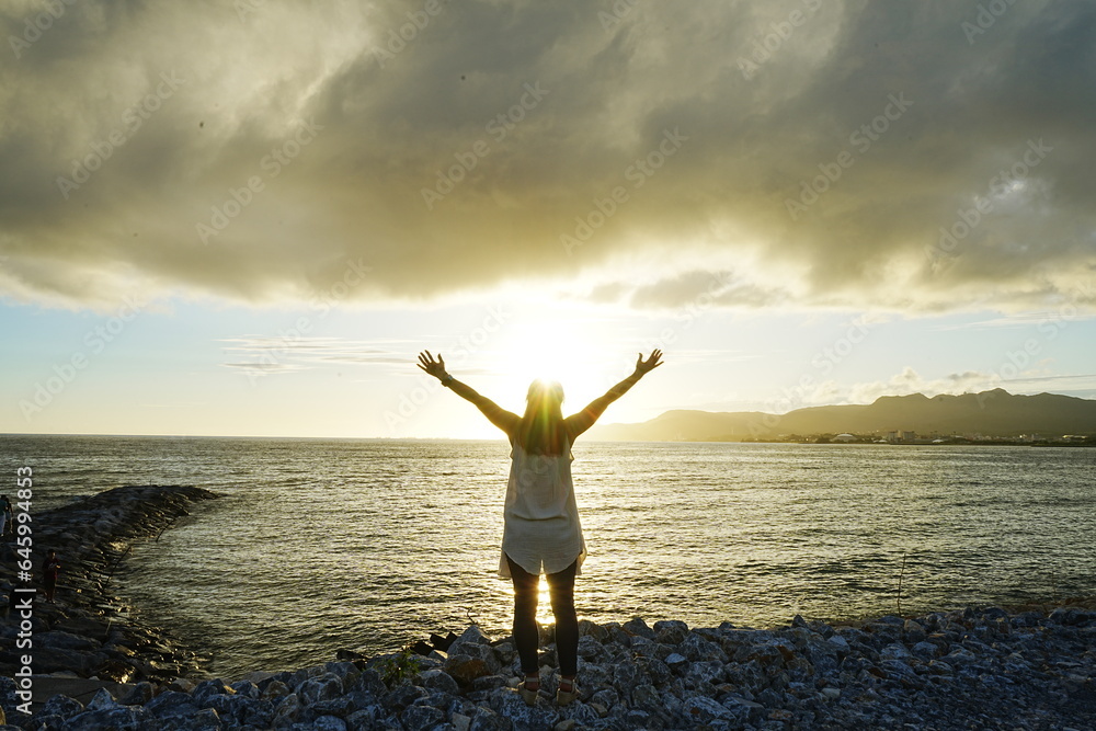 Woman seating in Sunset Image of Agarie Beach in Nago, Okinawa, Japan - 日本 沖縄 名護 東江ビーチに座る女性