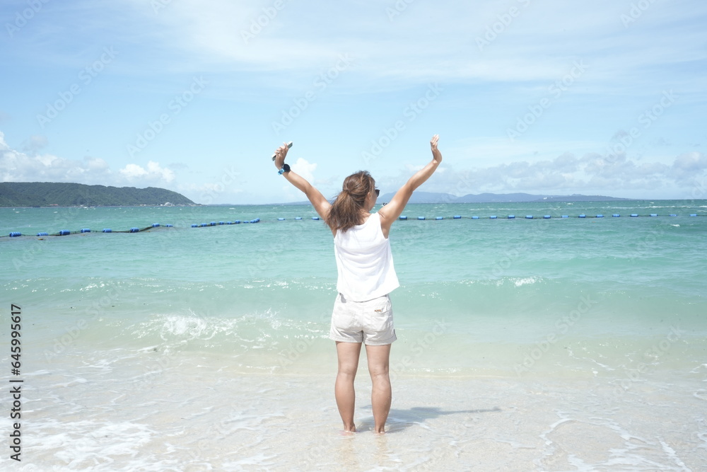 Woman Standing on the Beach in Onna, Okinawa, Japan - 日本 沖縄 恩納村 ビーチに立つ女性 Woman Standing on the Beach in Onna, Okinawa, Japan - 日本 沖縄 恩納村 ビーチに立つ女性