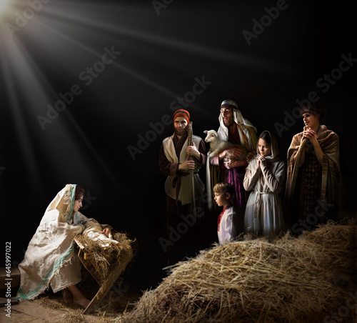 Mary sits in the stable near the manger with the baby photo