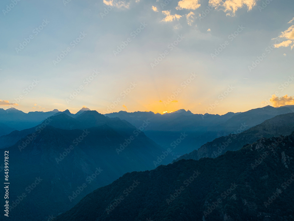 Obraz premium Beautiful alpine landscape with mountain range silhouette. Mountain peaks in the Alps.