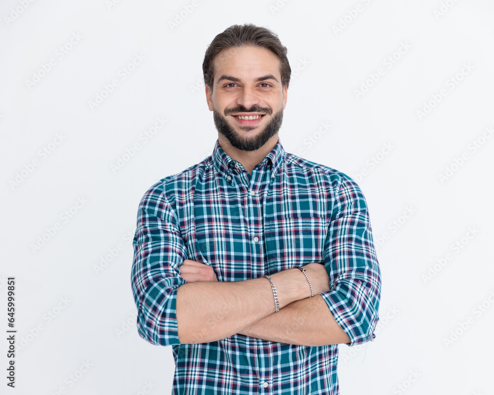 happy casual man in plaid shirt crossing arms and smiling happy casual man in plaid shirt crossing arms and smiling