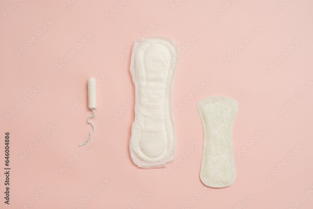 Different feminine sanitary napkins (sanitary pads) with tampon on pink background Different feminine sanitary napkins (sanitary pads) with tampon on pink background