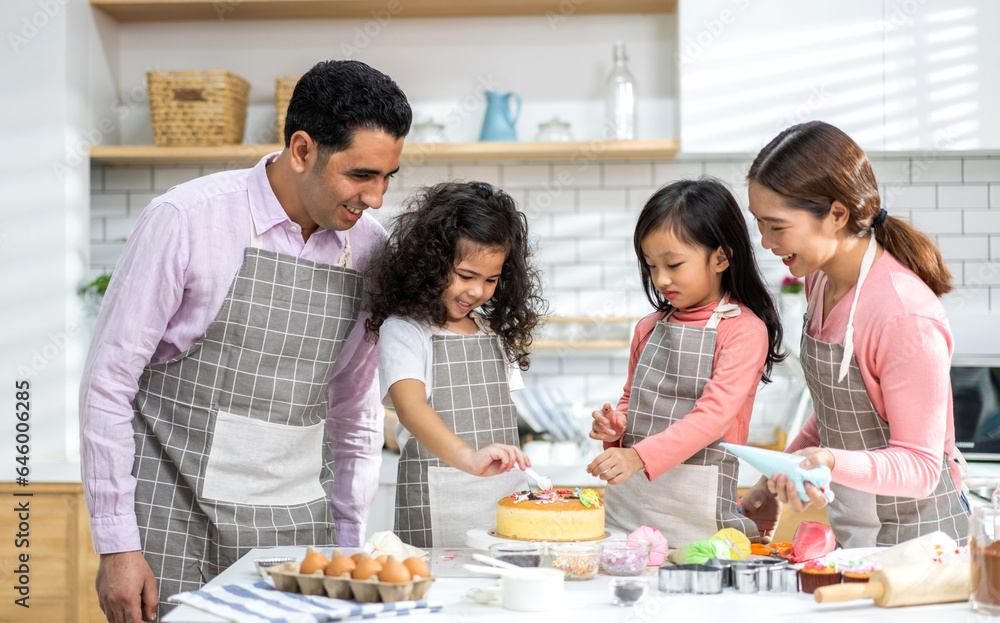 Portrait of enjoy happy love asian family father and mother with little asian girl daughter child play and having fun cooking food together with baking cookie and cake ingredient in kitchen