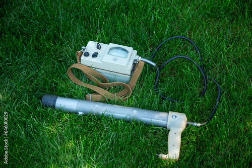 Soviet old dosimeter for measuring radiation on a green lawn photo