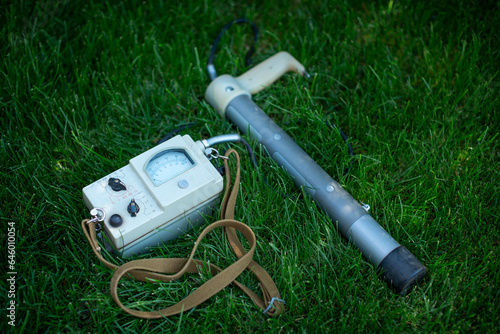 Soviet old dosimeter for measuring radiation on a green lawn photo