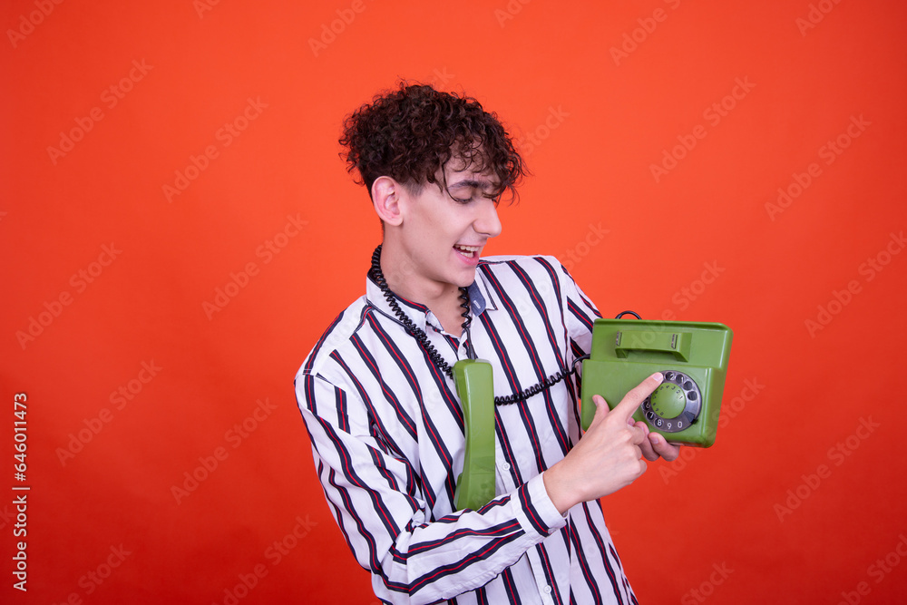 Funny curly guy posing in the studio on an orange background. Funny curly guy posing in the studio on an orange background.