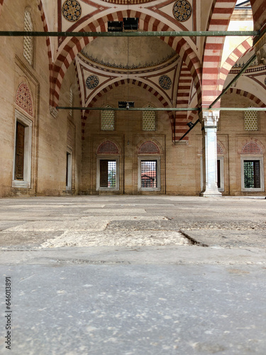 In terms of perspective, the stone arched domed mosque in the marble courtyard, shot from the ground and in focus, offers an aesthetic and historical view.