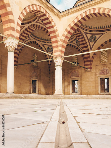In terms of perspective, the stone arched domed mosque in the marble courtyard, shot from the ground and in focus, offers an aesthetic and historical view.