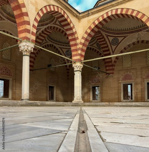 In terms of perspective, the stone arched domed mosque in the marble courtyard, shot from the ground and in focus, offers an aesthetic and historical view.