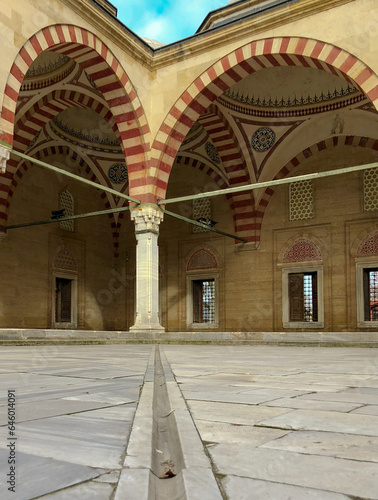 In terms of perspective, the stone arched domed mosque in the marble courtyard, shot from the ground and in focus, offers an aesthetic and historical view.