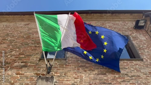 italian and european flags waving in the wind