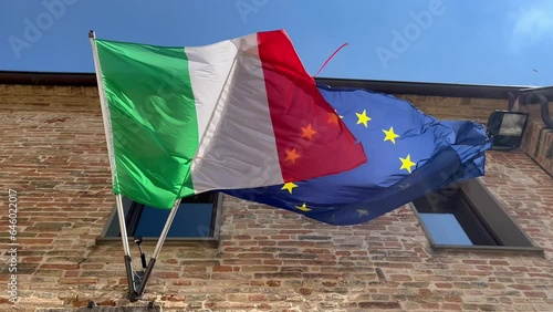 italian and european flags waving in the wind
