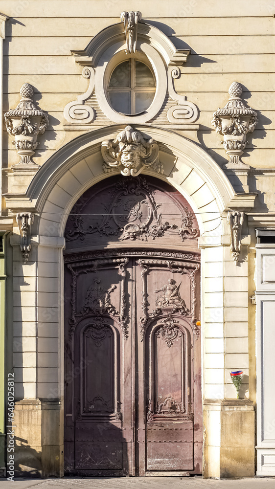 Paris, an ancient wooden door, beautiful facade in a luxury neighborhood, rue Saint-Dominique, in the 7e arrondissement
