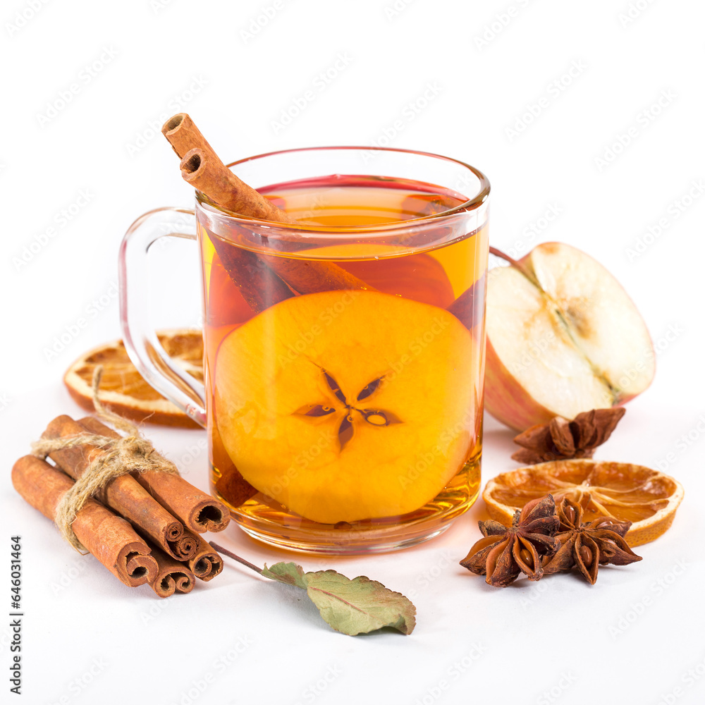 Warm drink concept for cold weather delight. Side view photo of a cup of flavored, hot apple cider with spices and anise on a white background Warm drink concept for cold weather delight. Side view photo of a cup of flavored, hot apple cider with spices and anise on a white background