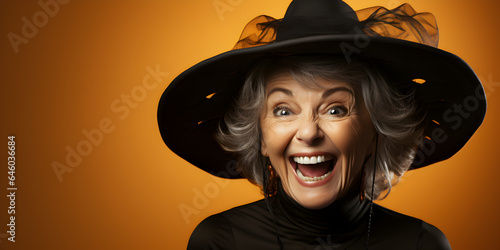 Papier peint Laughing Happy Adult Woman Wearing a Witches Costume for Halloween on an Orange