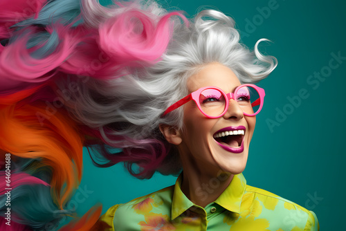 Happy mature business woman with gray hair  and pink glasses  colorful background