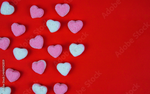 heart shaped sugar candy on red background