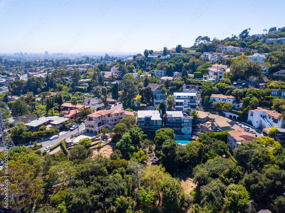 Aerial view of the Los Feliz neighborhood with large houses in the hills and downtown Los angeles skyline in the background. Aerial view of the Los Feliz neighborhood with large houses in the hills and downtown Los angeles skyline in the background.