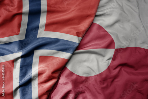 big waving national colorful flag of norway and national flag of greenland .
