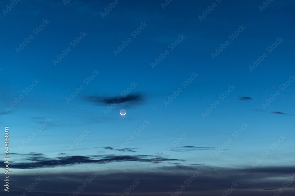 Moon and stars in twilight sky