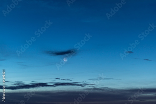 Moon and stars in twilight sky