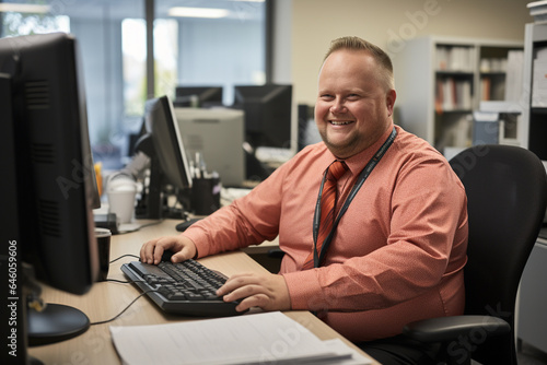 Smiling fat man in office at pc