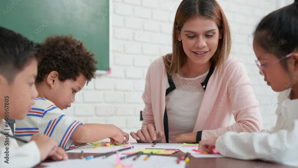 Students of different nationalities learning together in a classroom. Young female caucasian teacher working with little children group in class explaining. Back to kindergarten school. Students of different nationalities learning together in a classroom. Young female caucasian teacher working with little children group in class explaining. Back to kindergarten school.