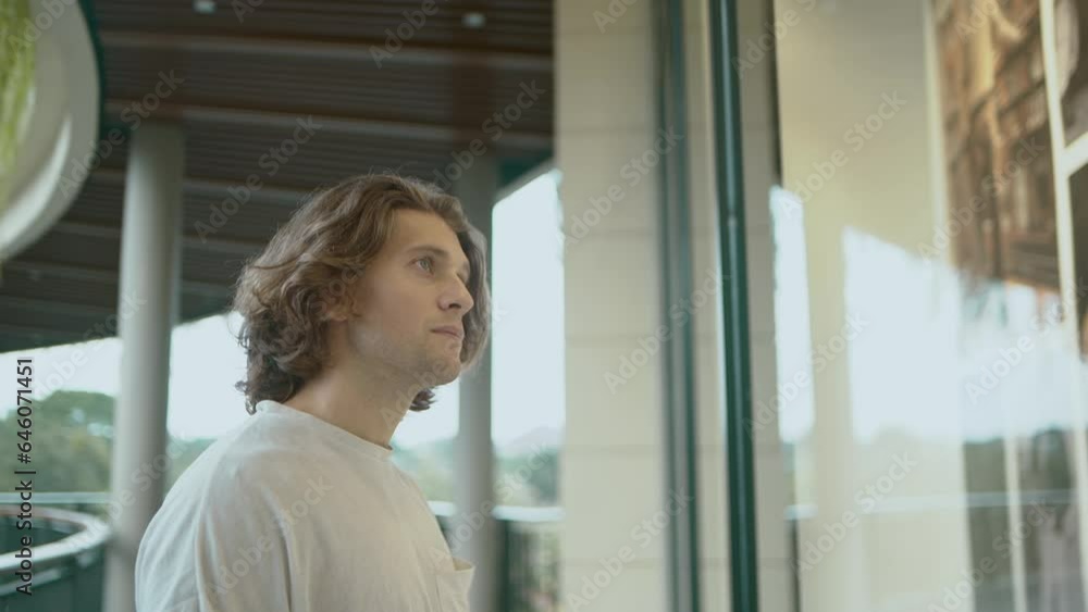 Young attractive man looking at shop window in the mall Young attractive man looking at shop window in the mall