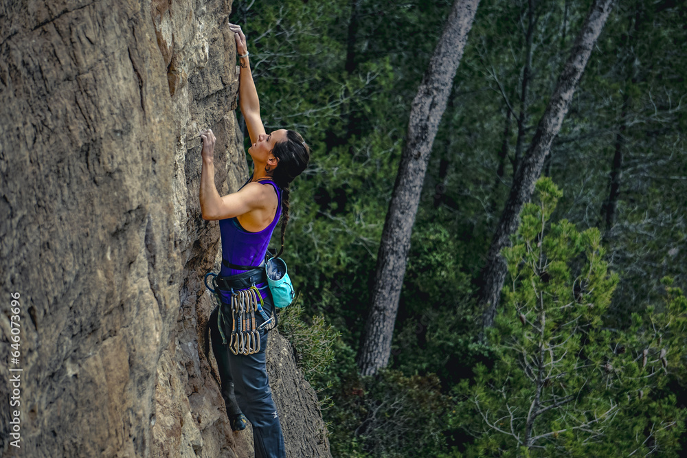 In the Wilderness: Determined Woman Climbing Amidst the Trees