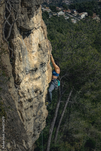 Woodland Ascent: Female Rock Climber in the Heart of Nature