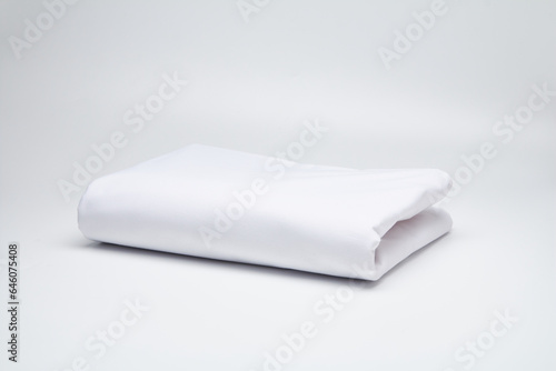 White, neatly folded fabric, mattress cover, sheet. Mattress covers. Production of mattress covers from cotton materials.