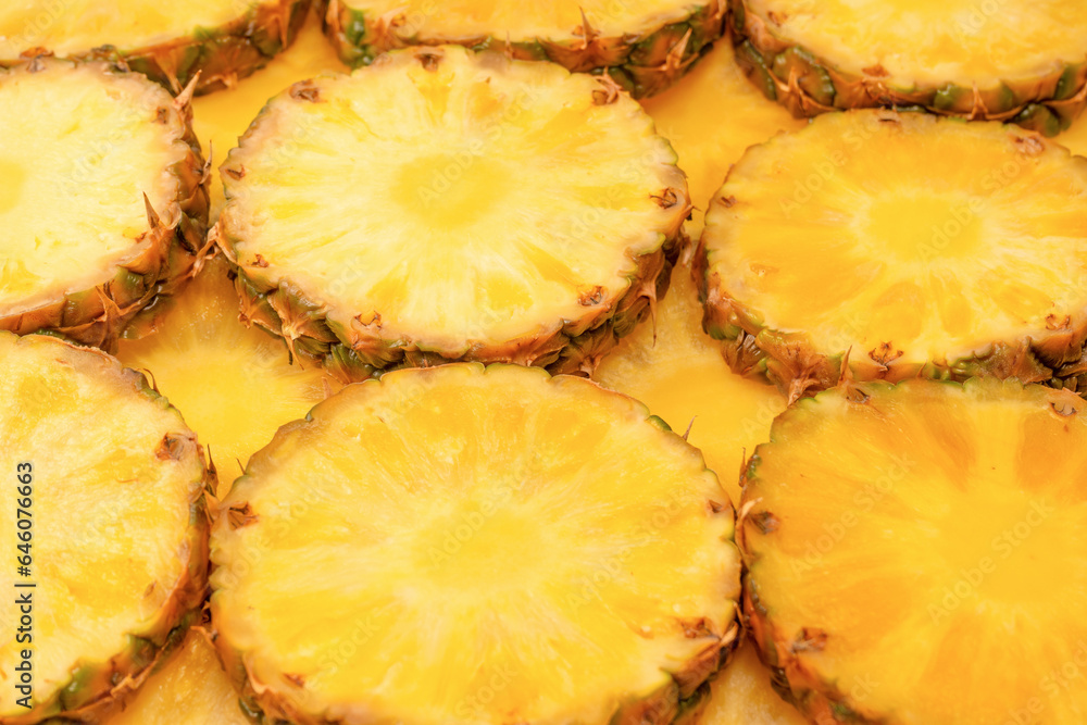 Pineapple juicy yellow slices as a background. Pineapple juicy yellow slices as a background.