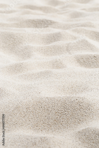 Fine Sand texture natural view. Close up of sand on shore sea, white waves dunes, beige neutral color, minimal nature aesthetic vertical photo. Sandy beach for background, selective focus