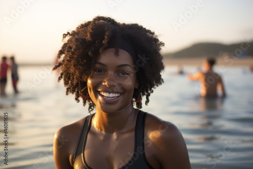 young black woman in the beach looking to the camera with a smile
