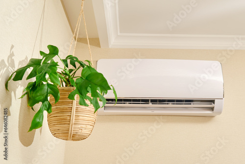 Quadro su tela The white air conditioner controls the temperature in the living room of the house