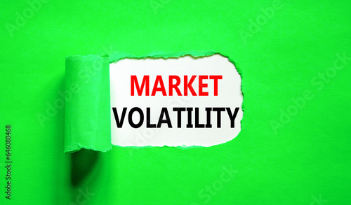 Market volatility symbol. Concept words Market volatility on beautiful white paper. Beautiful green paper background. Business market volatility concept. Copy space.orange
