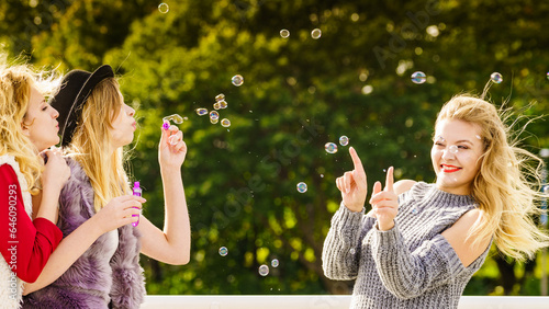 Women blowing soap bubbles  having fun